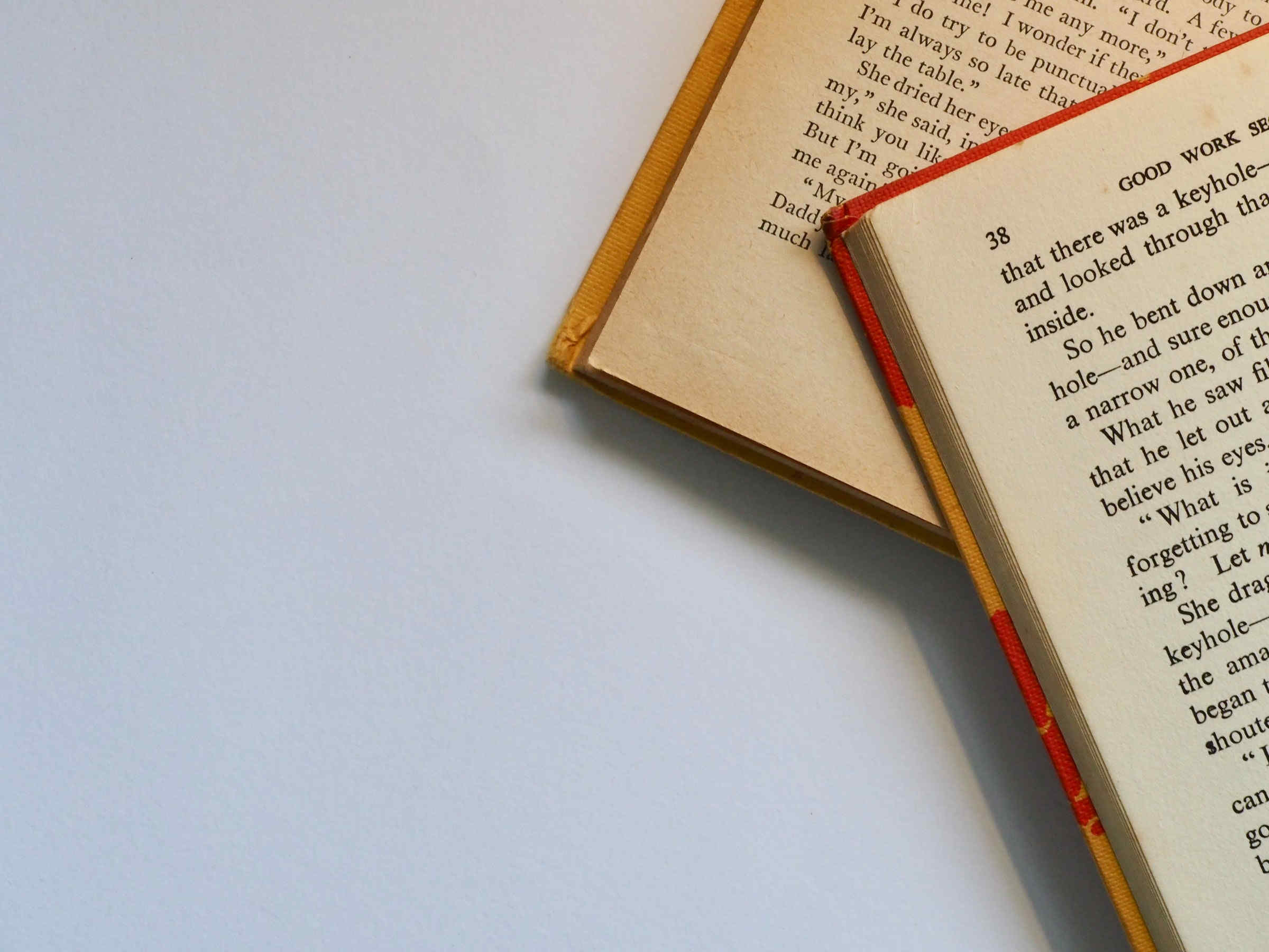 a small section of two book pages at the top and right corner